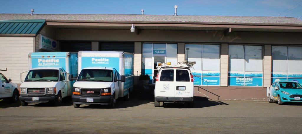 An image of Pacific Air Comfort building with a number of company trucks/cars seen in the front.